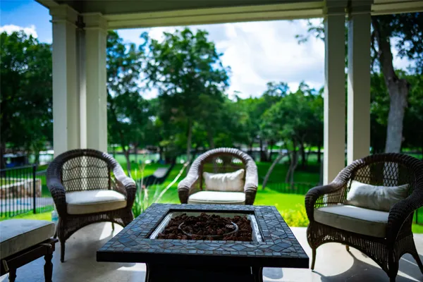 a view of a porch with chairs and backyard