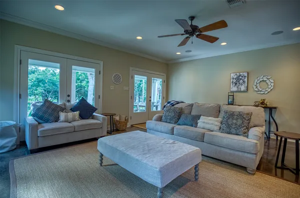 a living room with furniture and a ceiling fan