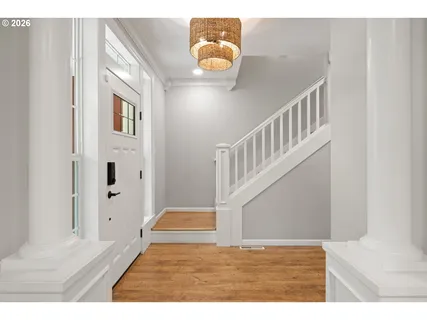 a view of entryway and hall with wooden floor