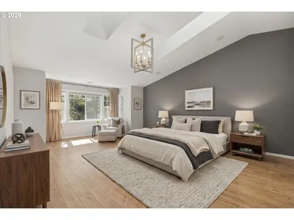 a bedroom with a bed a couch and dresser