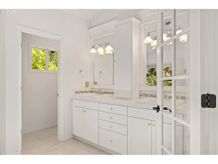 a bathroom with a double vanity sink and a mirror