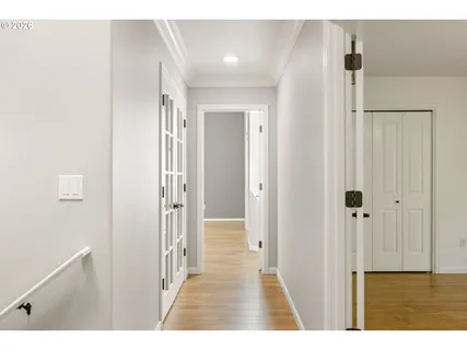a view of a hallway with wooden floor