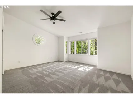 a view of a livingroom with a ceiling fan and window