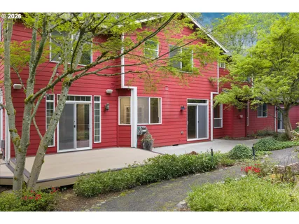 a front view of a house with a yard and potted plants
