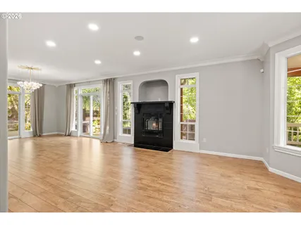 a view of a room wooden floor and windows