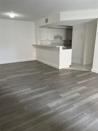a kitchen with stainless steel appliances a white stove top oven and cabinets