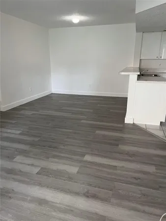 a view of a room with wooden floor