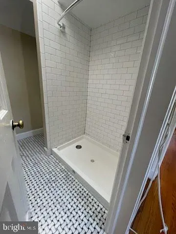 a bathroom with a bathtub and shower