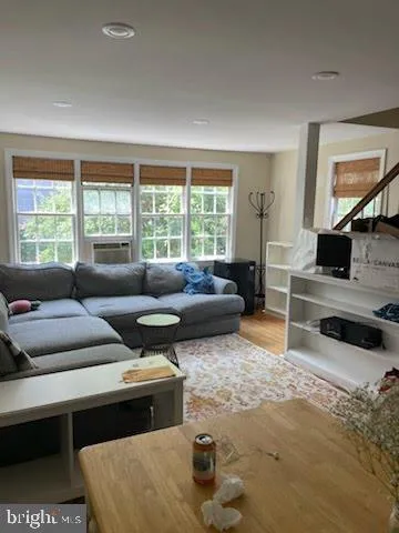 a kitchen with a checkered floor and white cabinets