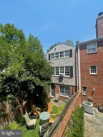a backyard of a house with outdoor seating