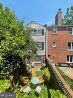 a view of a house with pool and a yard