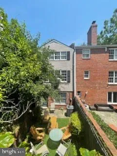 a room with a black white checkered floor with a gaming machine and glass windows