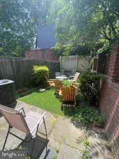 a view of backyard with seating space and trees