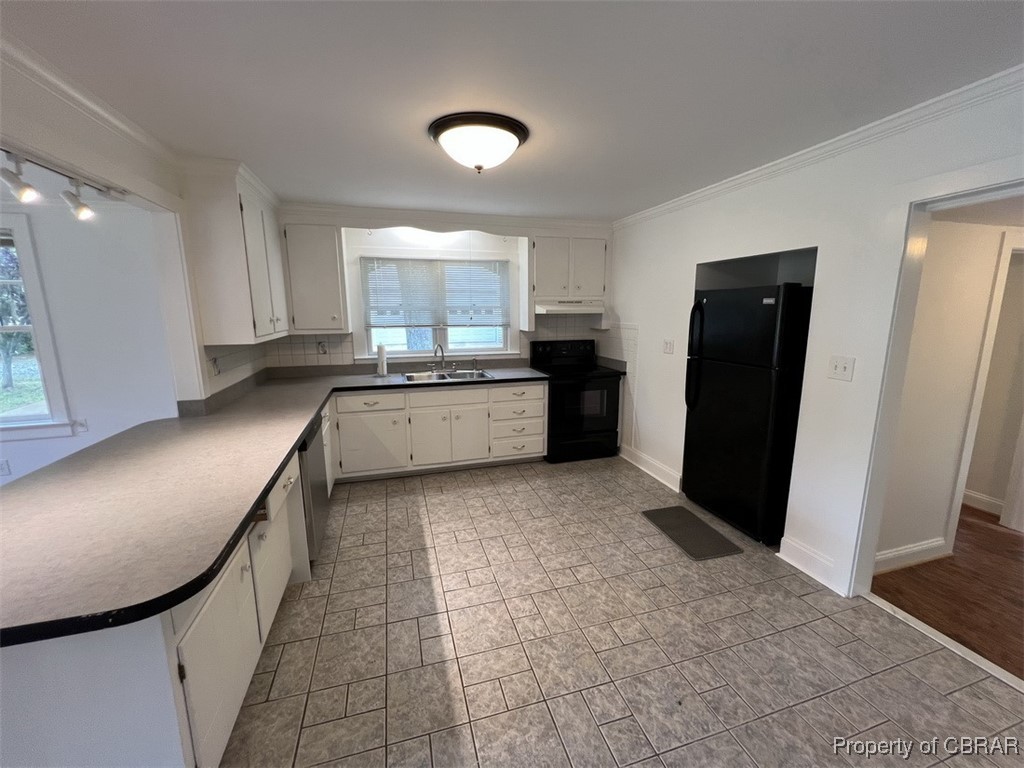 398 Philpot Road Locust Hill, VA 23092 - Photo 7 of 17 Kitchen with black appliances, under cabinet range hood, a sink, white cabinetry, and ornamental molding