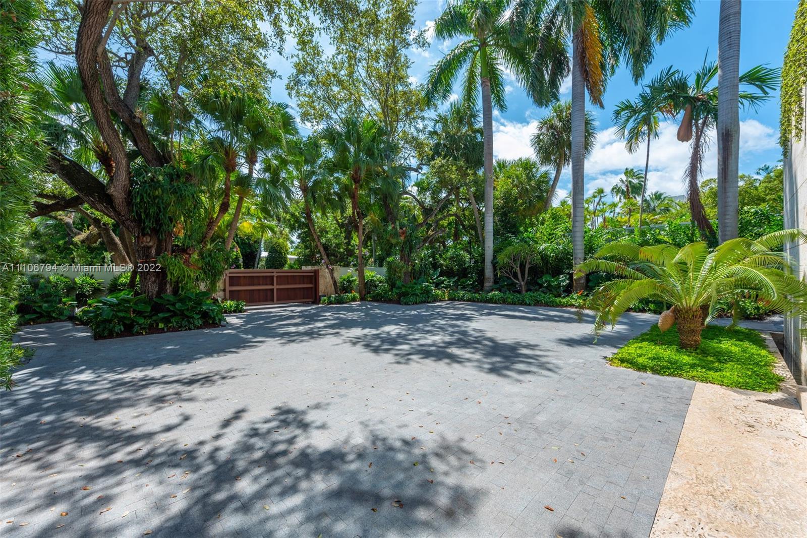 6396 North Bay Road Miami Beach, FL 33140 - Photo 6 of 12 a wooden bench with view of tree