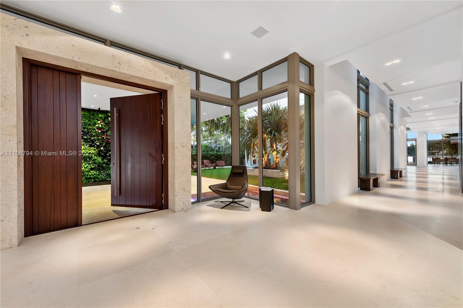 6396 North Bay Road Miami Beach, FL 33140 - Photo 10 of 12 a view of a hallway with a large mirror and door