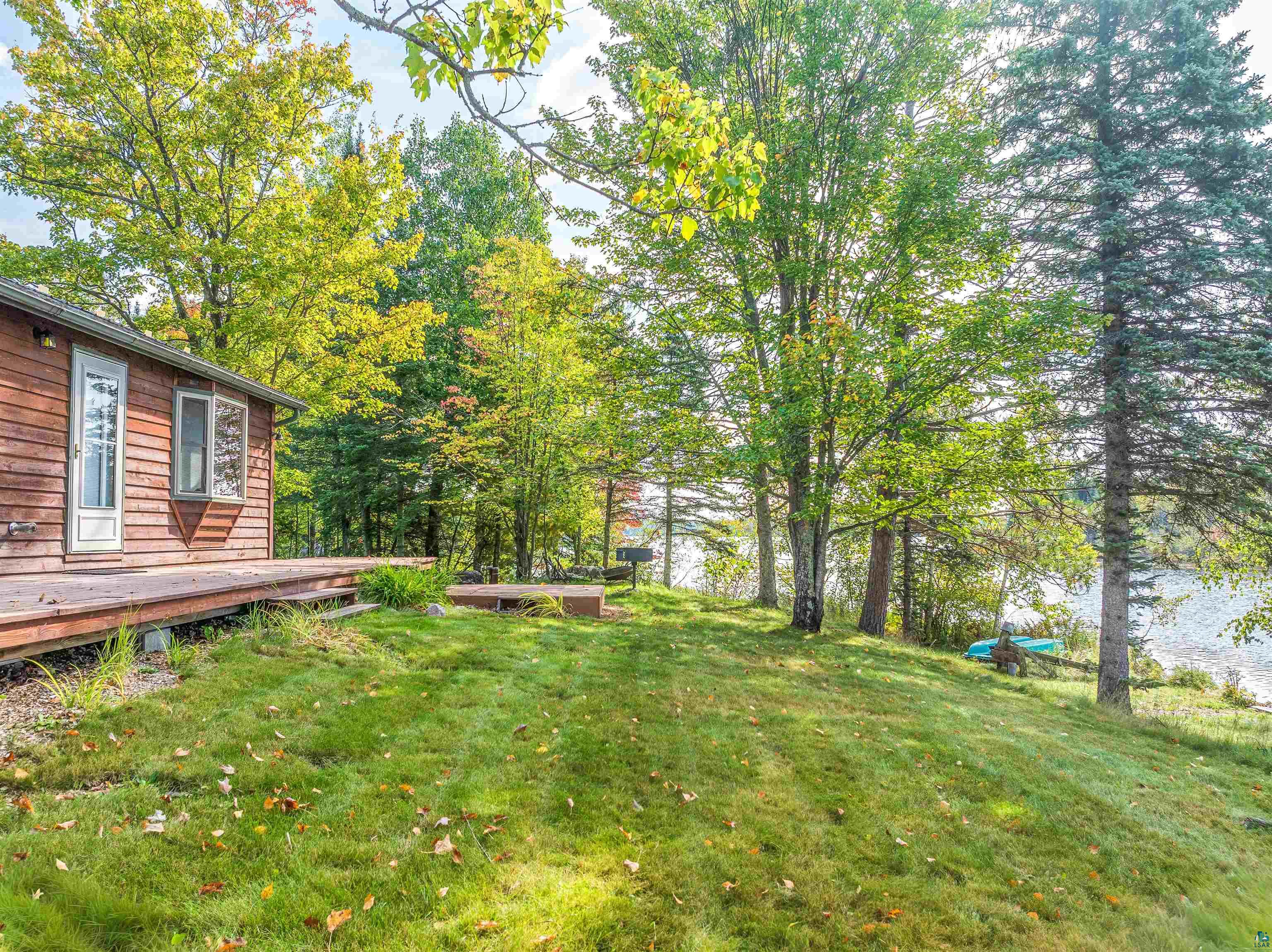 2734 Bear Island River Road Ely, MN 55731 - Photo 35 of 37 View of grassy yard featuring a wooden deck and view of scattered trees