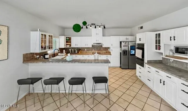 a view of a dining room with furniture and a chandelier