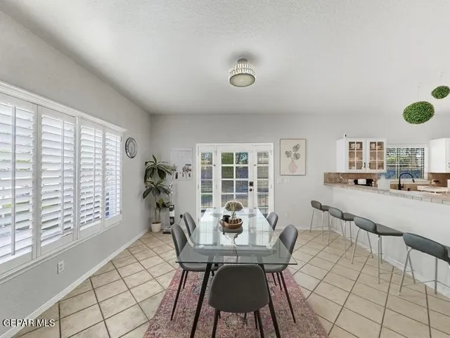 a kitchen with granite countertop white cabinets and stainless steel appliances