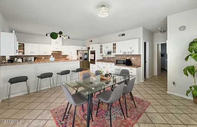 a view of a dining room with furniture and a potted plant