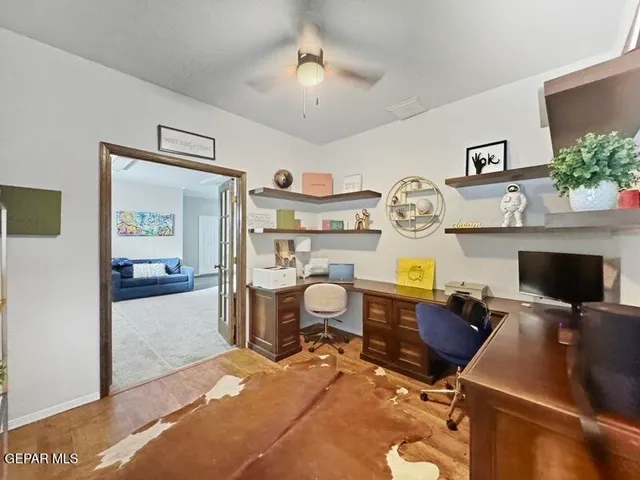 a living room with furniture and a ceiling fan