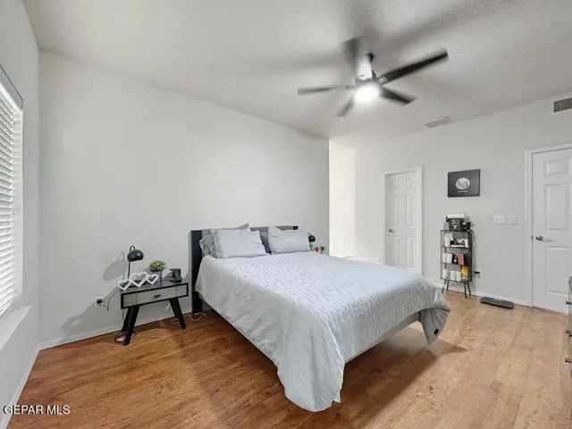 a spacious bathroom with a granite countertop sink and a mirror