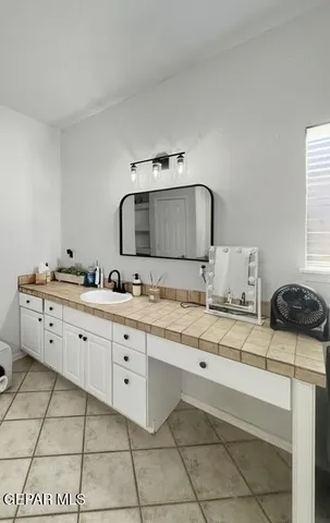 a bathroom with a double vanity sink and mirror