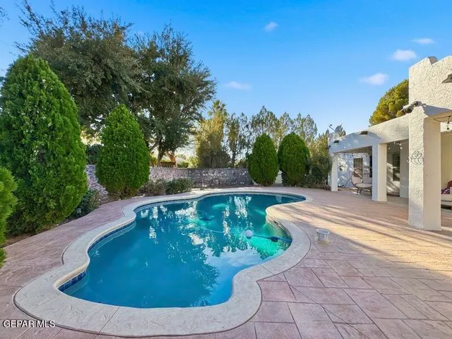 a view of a house with a yard potted plants