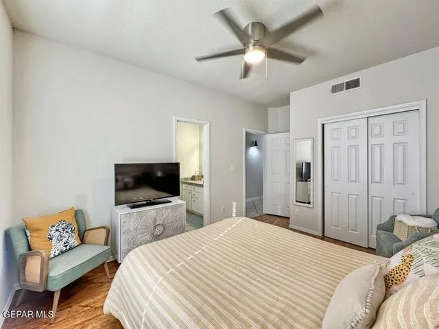 a bedroom with a bed and a large mirror