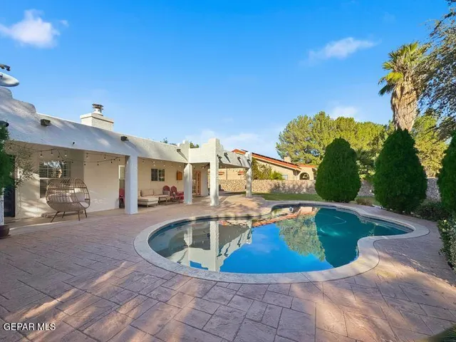 a view of a swimming pool with outdoor seating