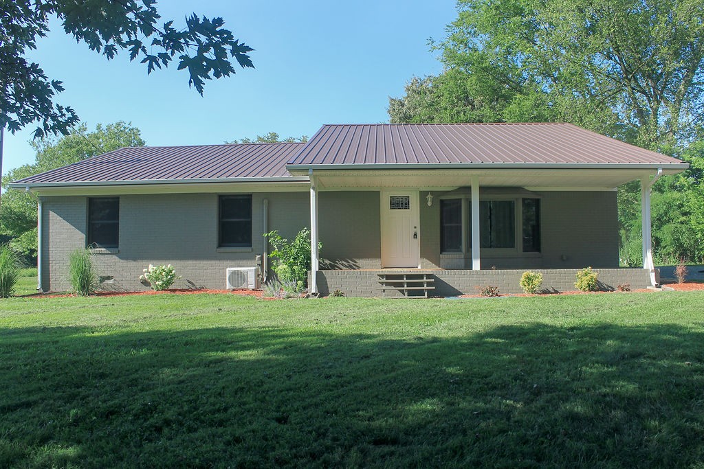 a view of a house with a yard porch and sitting area