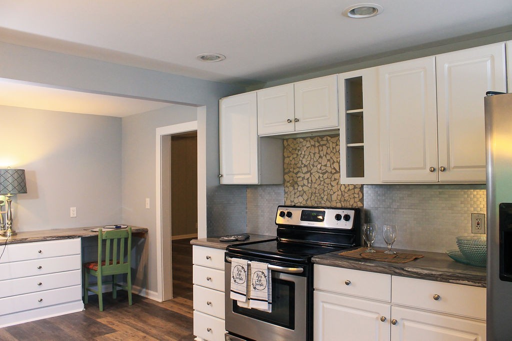 288 Clubbs Road Portland, TN 37148 - Photo 12 of 48 a kitchen with granite countertop a stove and cabinets
