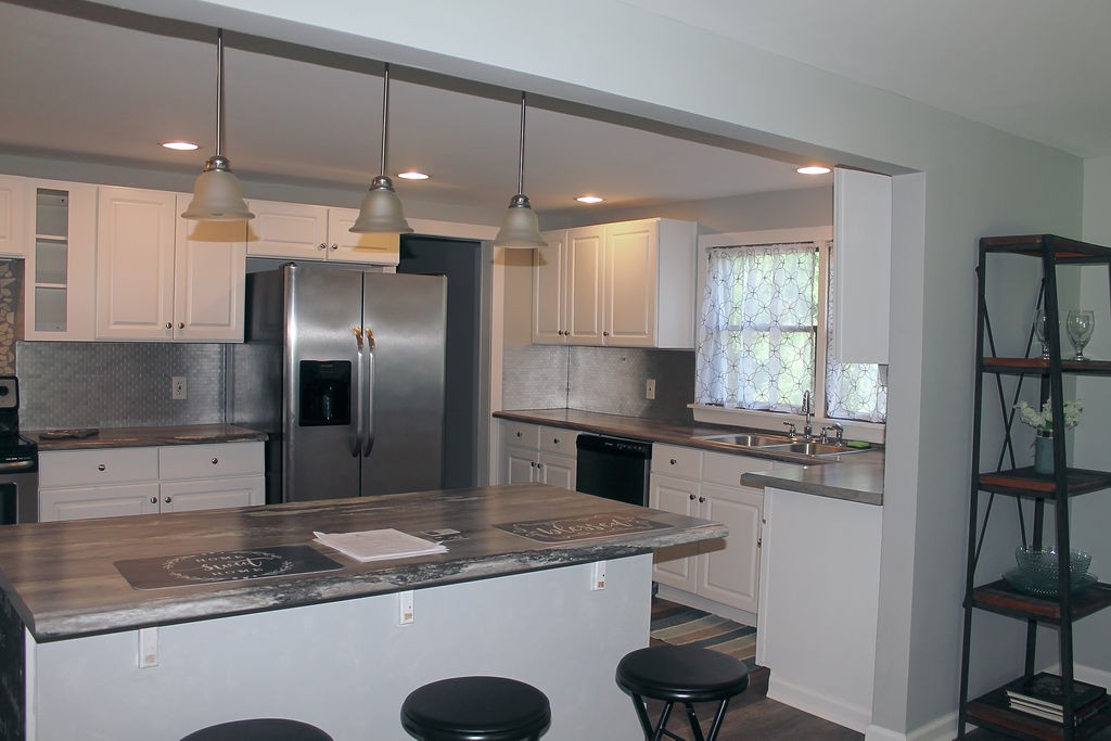 288 Clubbs Road Portland, TN 37148 - Photo 13 of 48 a kitchen with a stove a sink and a refrigerator
