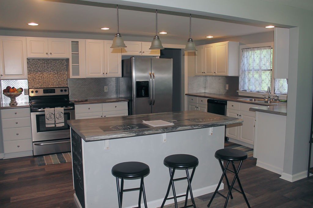 288 Clubbs Road Portland, TN 37148 - Photo 20 of 48 a kitchen with kitchen island a counter space a sink appliances and cabinets