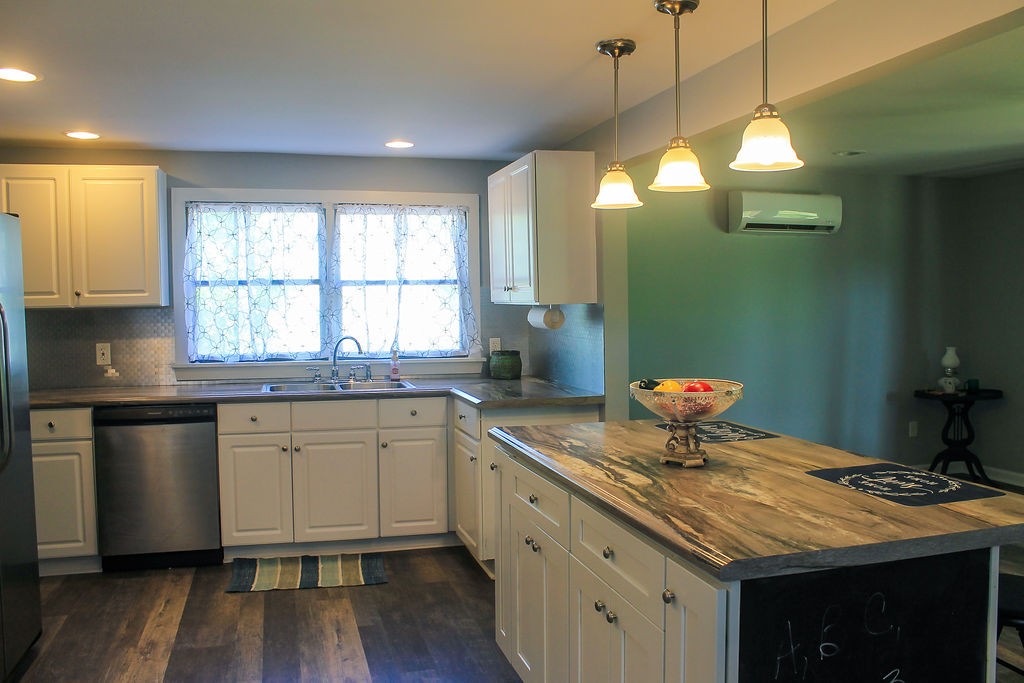 288 Clubbs Road Portland, TN 37148 - Photo 7 of 48 a kitchen with granite countertop a sink a window stainless steel appliances and cabinets