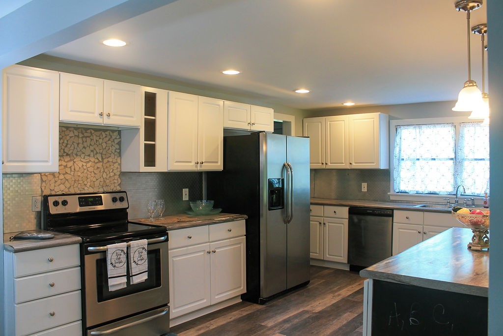 288 Clubbs Road Portland, TN 37148 - Photo 8 of 48 a kitchen with stainless steel appliances granite countertop a refrigerator a sink dishwasher a stove and white cabinets with wooden floor
