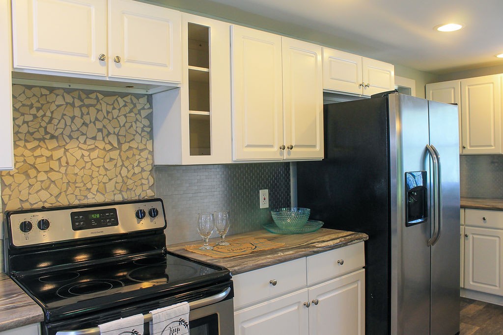 288 Clubbs Road Portland, TN 37148 - Photo 9 of 48 a kitchen with stainless steel appliances granite countertop a stove and a refrigerator