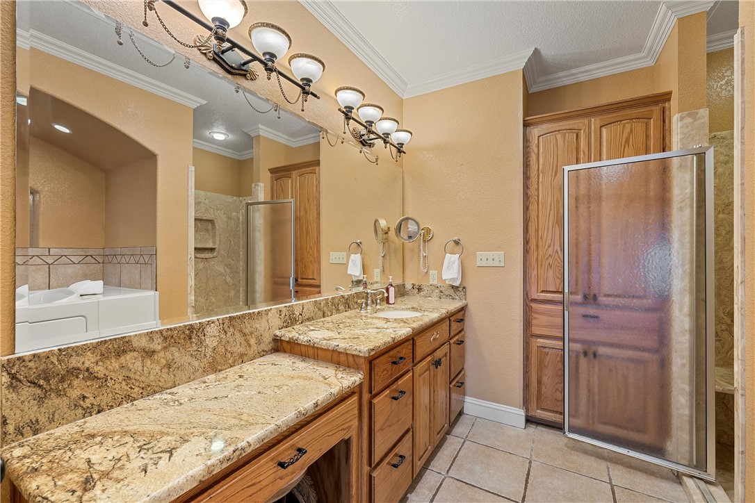 113 Cr 453 Road Troy, TX 76579 - Photo 20 of 41 a bathroom with a granite countertop sink a mirror and a shower