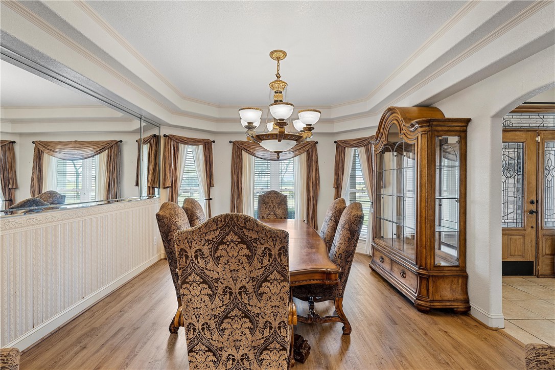 113 Cr 453 Road Troy, TX 76579 - Photo 7 of 41 a dining room with furniture a chandelier and wooden floor