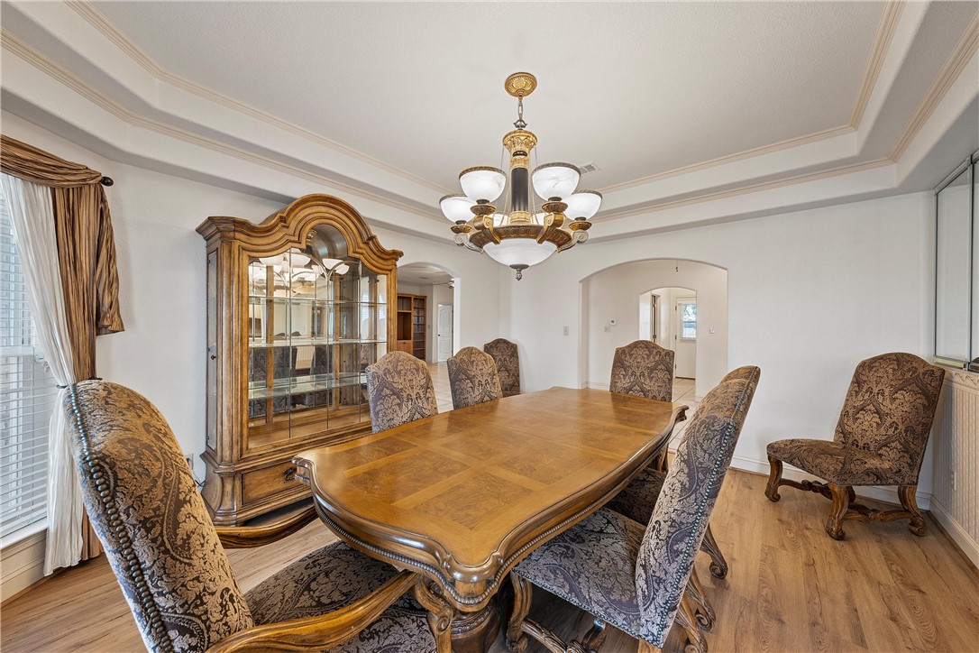 113 Cr 453 Road Troy, TX 76579 - Photo 8 of 41 a dining room with furniture a chandelier and wooden floor