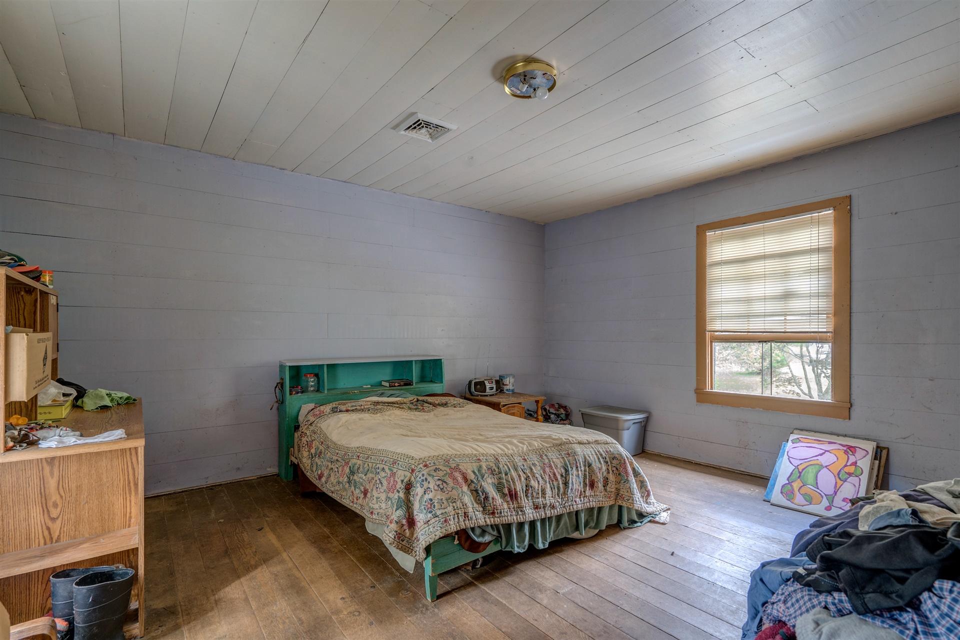 6051 Ferrum Mountain Road Callaway, VA 24067 - Photo 12 of 14 a bedroom with a bed and wooden floor