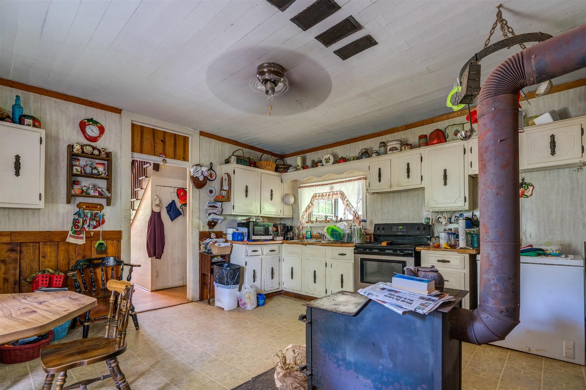 6051 Ferrum Mountain Road Callaway, VA 24067 - Photo 5 of 14 a kitchen with stainless steel appliances granite countertop a refrigerator and stove top oven