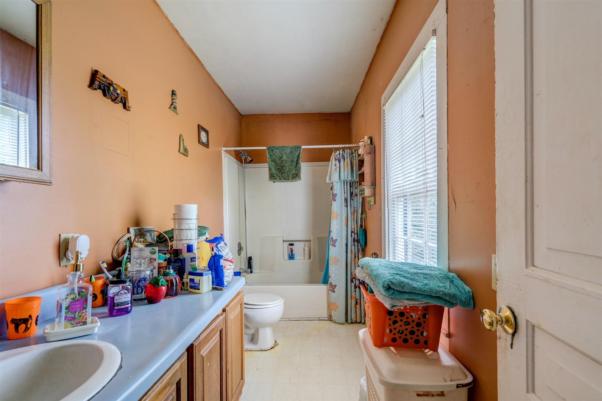 6051 Ferrum Mountain Road Callaway, VA 24067 - Photo 10 of 14 a bathroom with a sink mirror vanity and toilet