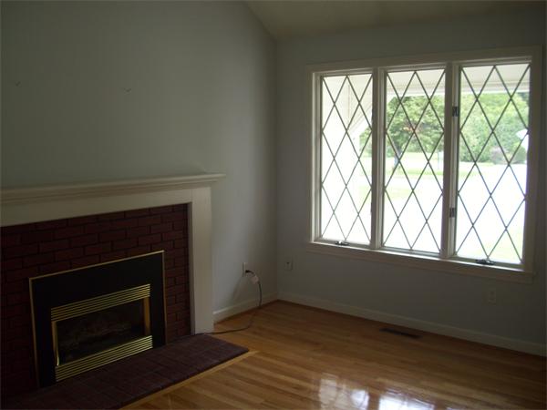 31 Bear Hole Road West Springfield, MA 01089 - Photo 7 of 14 a living room with a fireplace and a floor to ceiling window