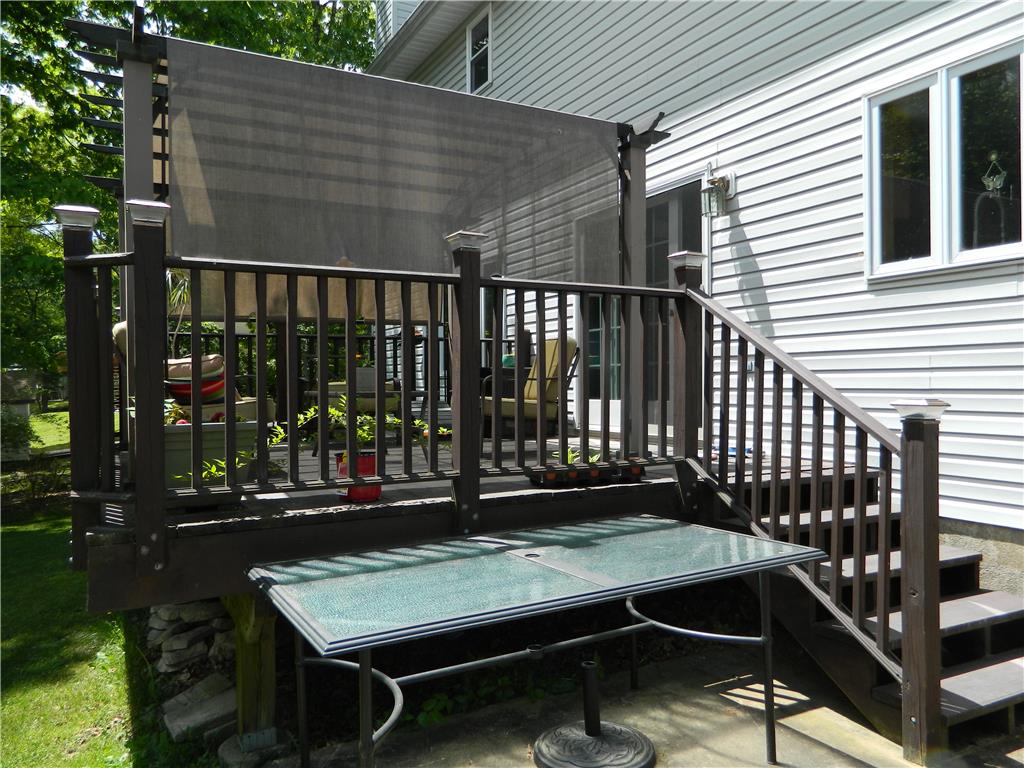 328 Pin Oak Road Stroudsburg, PA 18360 - Photo 4 of 37 A welcoming deck with a privacy screen provides an outdoor haven for relaxation and entertaining.