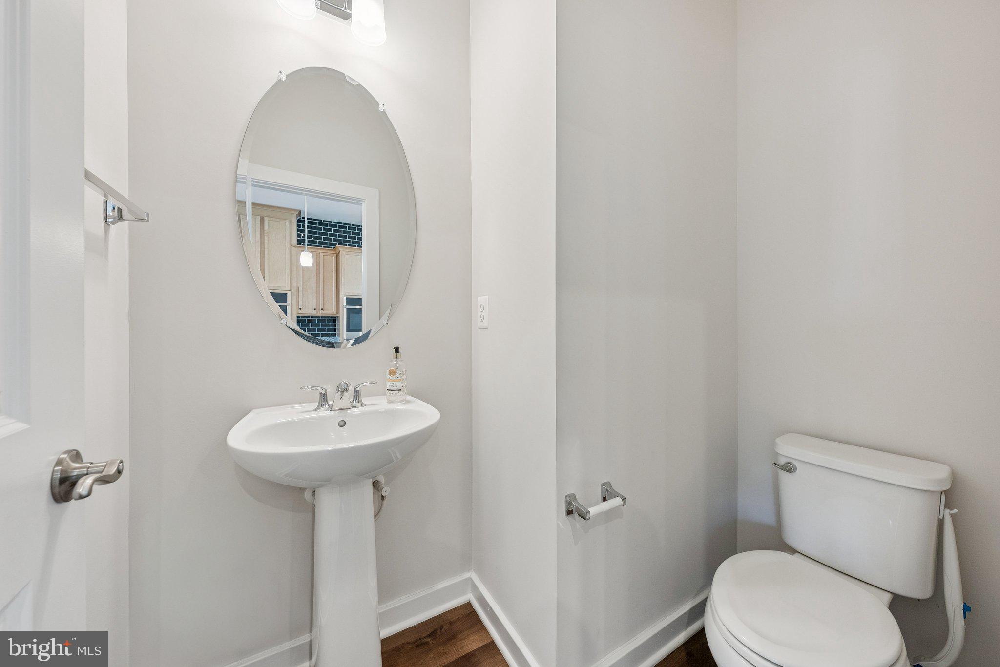 1655 Aspen Poplar Road Dumfries, VA 22026 - Photo 14 of 57 a bathroom with a toilet sink and mirror