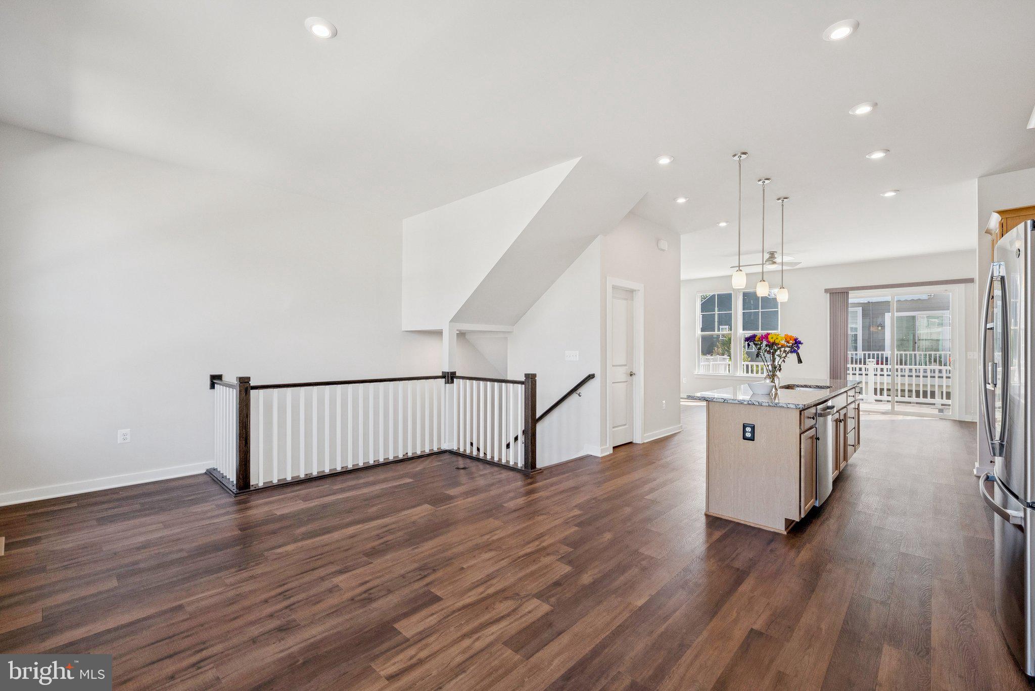 1655 Aspen Poplar Road Dumfries, VA 22026 - Photo 51 of 57 a kitchen with stainless steel appliances wooden floors and white walls