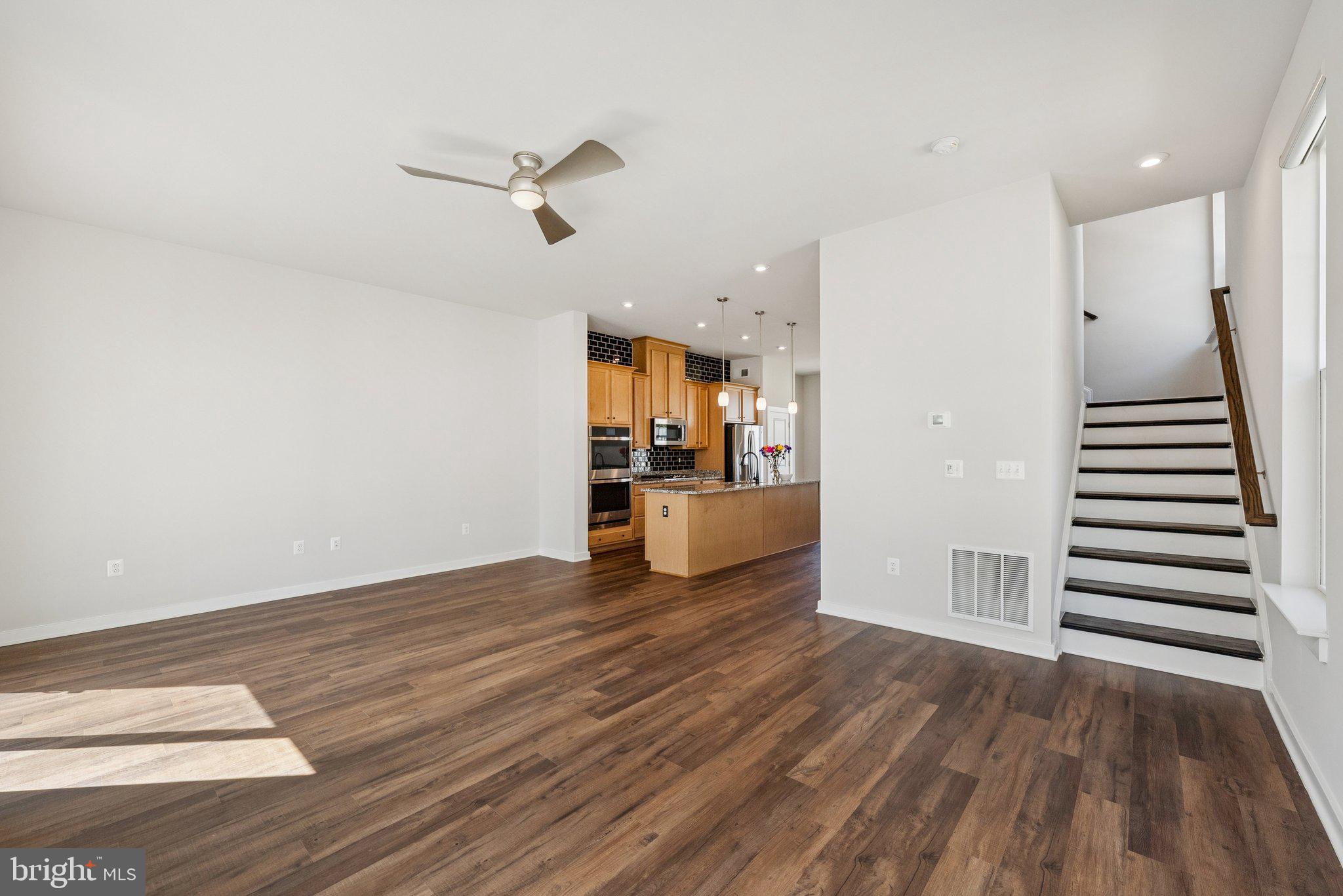 1655 Aspen Poplar Road Dumfries, VA 22026 - Photo 21 of 57 a view of a kitchen with wooden floor and a ceiling fan