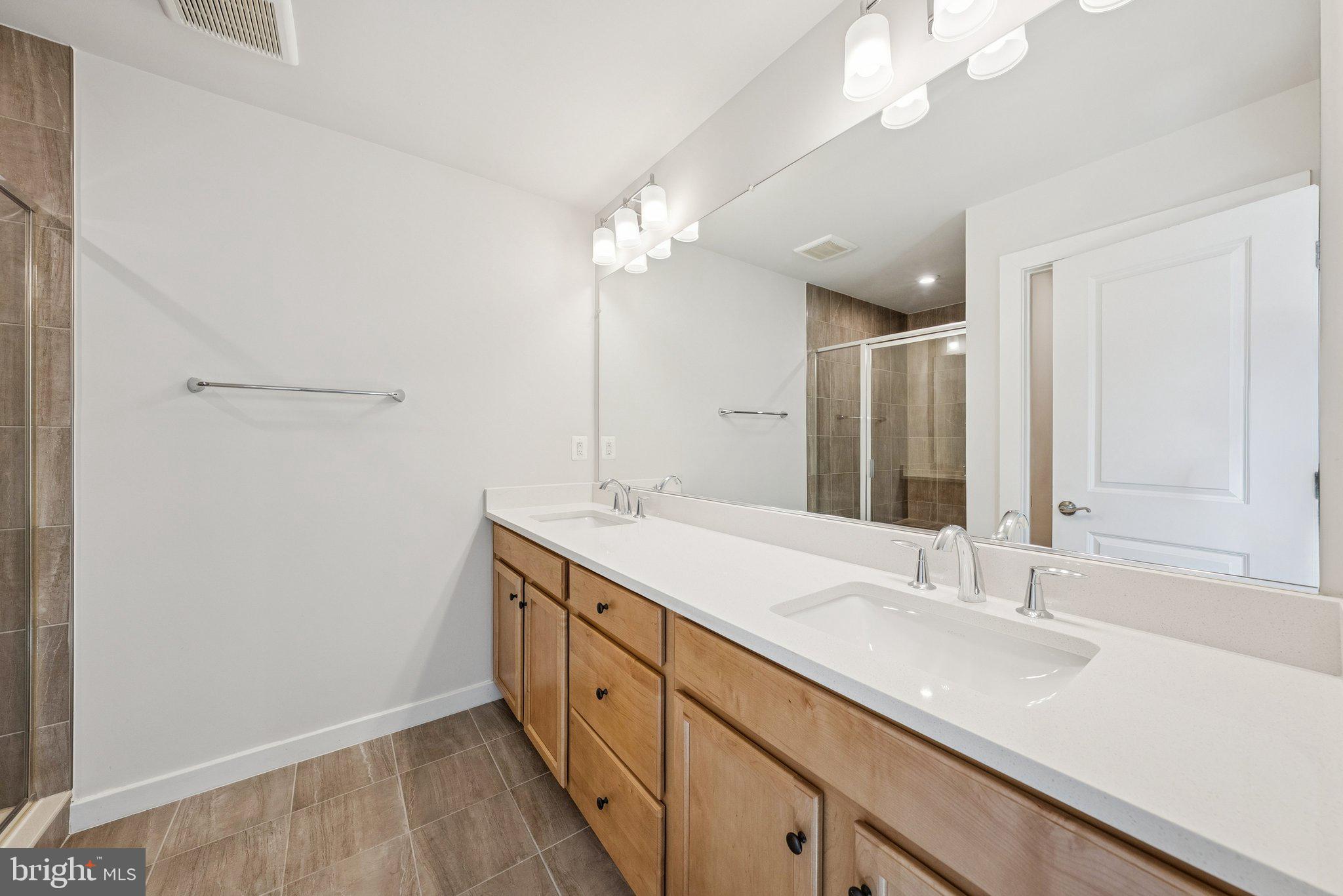 1655 Aspen Poplar Road Dumfries, VA 22026 - Photo 31 of 57 a bathroom with a sink a vanity and a large mirror