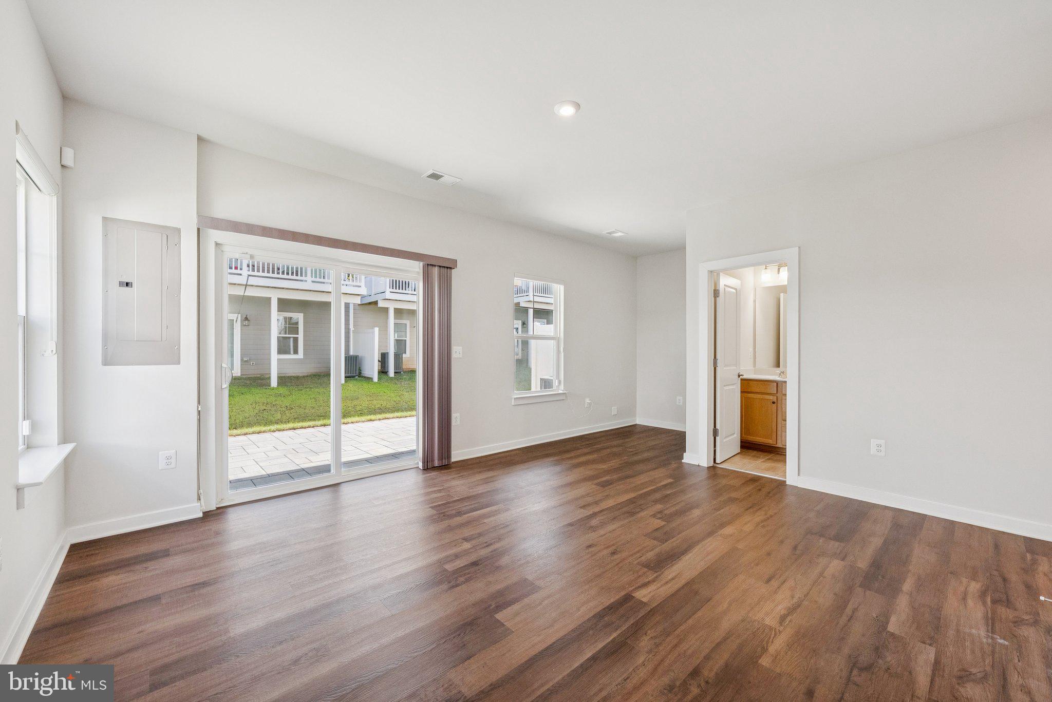 1655 Aspen Poplar Road Dumfries, VA 22026 - Photo 6 of 57 a view of an empty room with wooden floor and a window